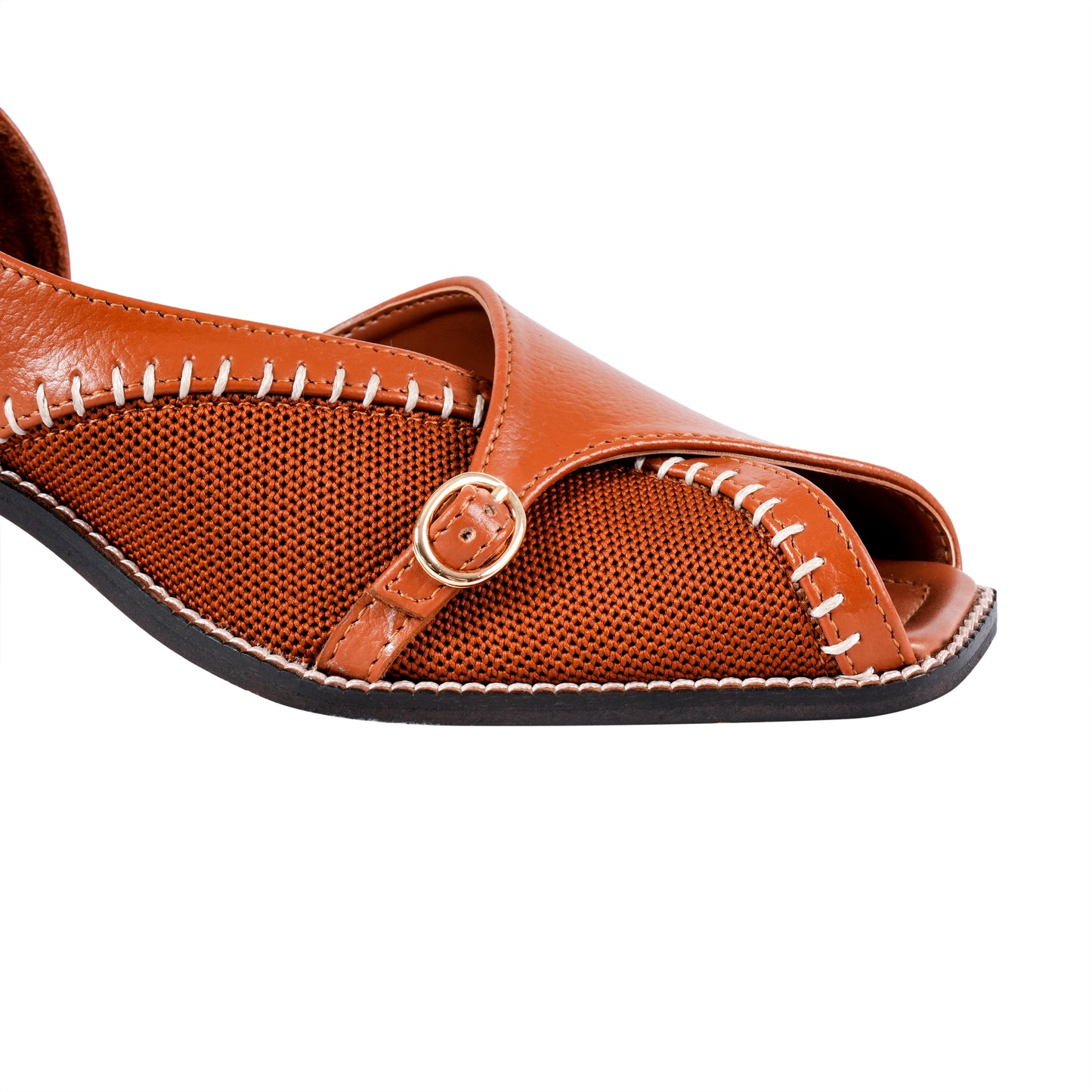 Tan sandal with a buckle on a white background