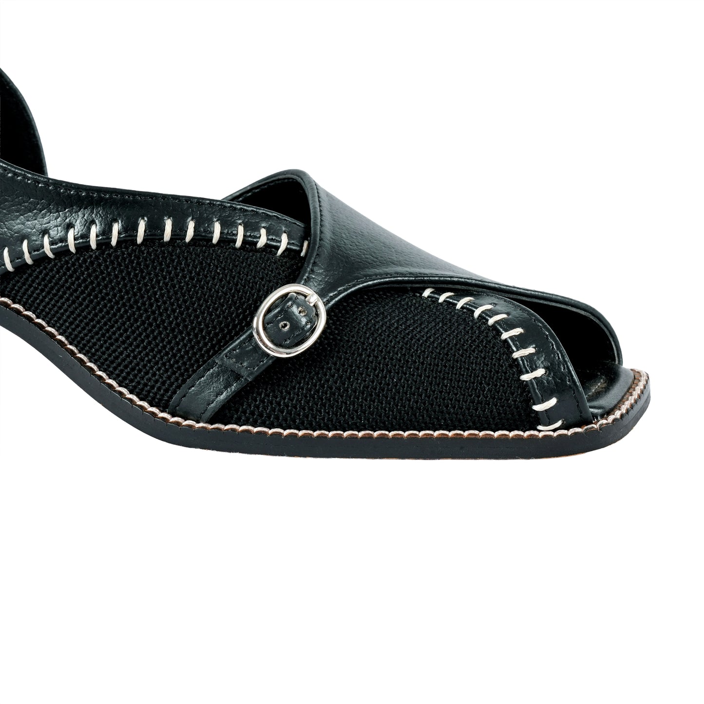 Black sandal with open toe and metallic buckle on a white background