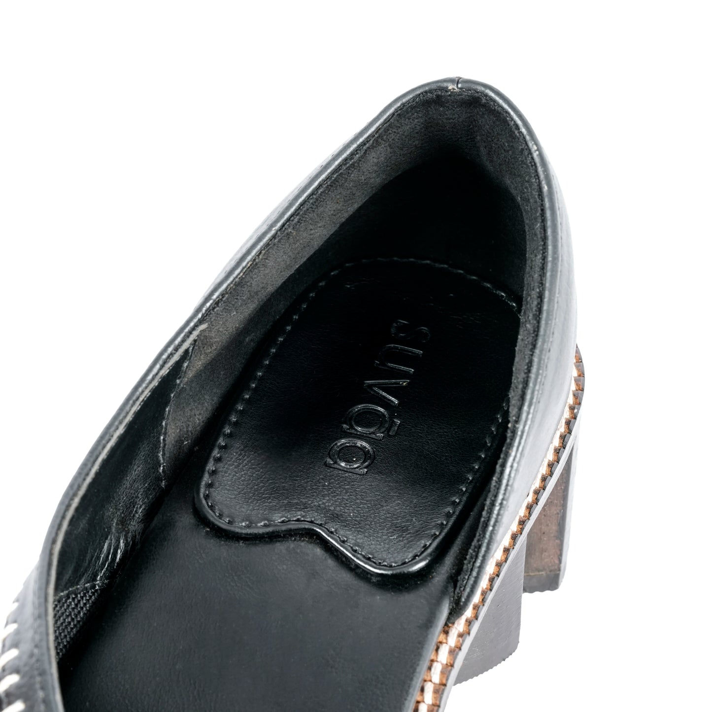 Close-up of a Black shoe with a Suvāa logo on a white background