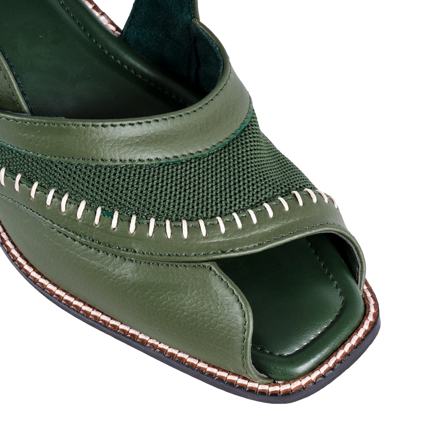 Green sandal with open toe and detailed stitching on a white background