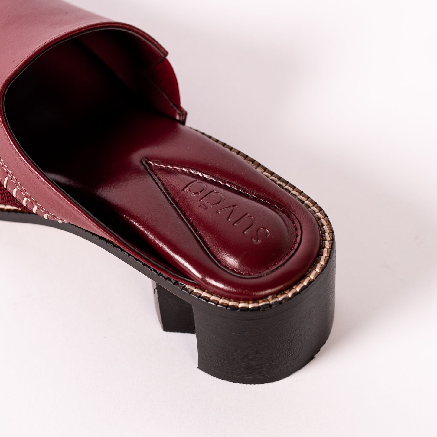 Burgundy sandal with block heel on a white background